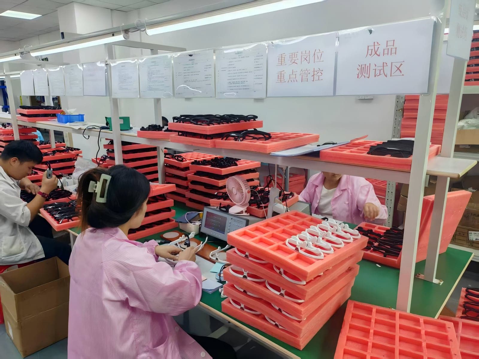 Finished smart glasses being inspected at factory testing stations